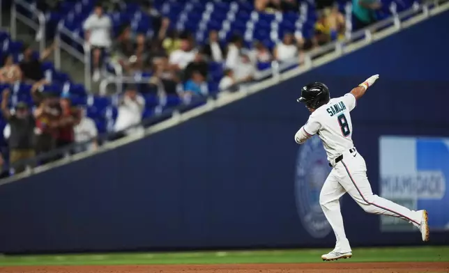 Miami Marlins' Javier Sanoja celebrates as he runs the bases after hitting a grand slam to bring home Jakob Marsee, Connor Norby, and Joe Mack, during the fifth inning of a baseball game against the Atlanta Braves, Monday, May 18, 2026, in Miami. (AP Photo/Rebecca Blackwell)
