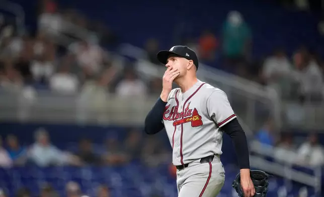 Atlanta Braves relief pitcher Aaron Bummer reacts as he leaves the field after pitching during the fifth inning of a baseball game against the Miami Marlins, Monday, May 18, 2026, in Miami. (AP Photo/Rebecca Blackwell)