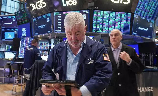 Trader Edward McCarthy, center, works on the floor of the New York Stock Exchange, Tuesday, May 5, 2026. (AP Photo/Richard Drew)