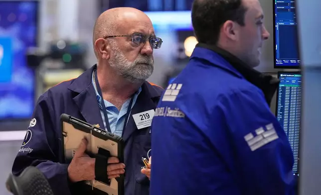 Trader Joseph Stevens, left, works on the floor of the New York Stock Exchange, Tuesday, May 5, 2026. (AP Photo/Richard Drew)