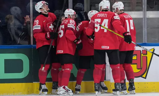 Switzerland's Ken Jager (62) celebrates after scoring his side's second goal during the 2026 IIHF Men's Ice Hockey World Championship semifinal match between Switzerland and Norway, in Zurich, Switzerland, Saturday, May 30, 2026, (AP Photo/Darko Bandic)