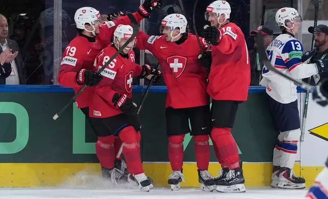 Switzerland's Ken Jager (62) celebrates after scoring his side's second goal during the 2026 IIHF Men's Ice Hockey World Championship semifinal match between Switzerland and Norway, in Zurich, Switzerland, Saturday, May 30, 2026, (AP Photo/Darko Bandic)
