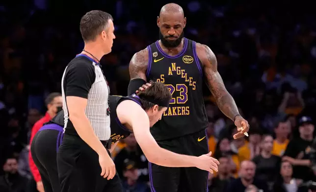 Los Angeles Lakers forward LeBron James, right, pats guard Austin Reaves on the head after Reaves missed a three-point shot with 11 seconds left in Game 4 of a second-round NBA basketball playoffs series against the Oklahoma City Thunder, Monday, May 11, 2026, in Los Angeles. (AP Photo/Mark J. Terrill)