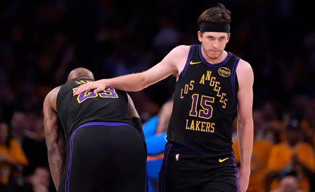 Los Angeles Lakers guard Austin Reaves, right, pats the back of forward LeBron James in the closing minutes of Game 4 in a second-round NBA basketball playoffs series against the Oklahoma City Thunder, Monday, May 11, 2026, in Los Angeles. (AP Photo/Mark J. Terrill)