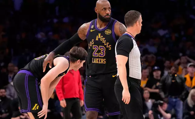 Los Angeles Lakers forward LeBron James, right, pats guard Austin Reaves after Reaves missed a three-point shot with 11 seconds left in Game 4 of a second-round NBA basketball playoffs series against the Oklahoma City Thunder, Monday, May 11, 2026, in Los Angeles. (AP Photo/Mark J. Terrill)