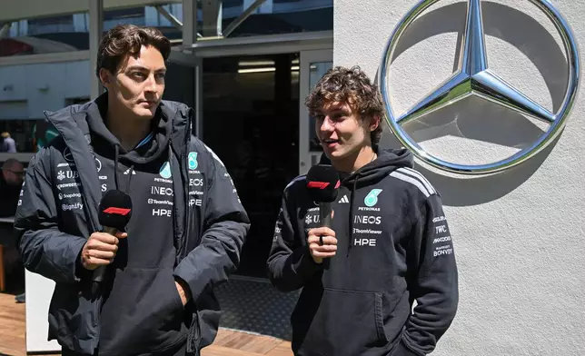 Mercedes drivers George Russell of Britain, left, and Kimi Antonelli of Italy speak during an interview in the paddocks at the F1 Canadian Grand Prix auto race in Montreal, Thursday, May 21, 2026. (Graham Hughes/The Canadian Press via AP)