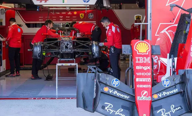 Ferrari team members work on their cars at the F1 Canadian Grand Prix auto race, Thursday, May 21, 2026, in Montreal. (Christinne Muschi/The Canadian Press via AP)