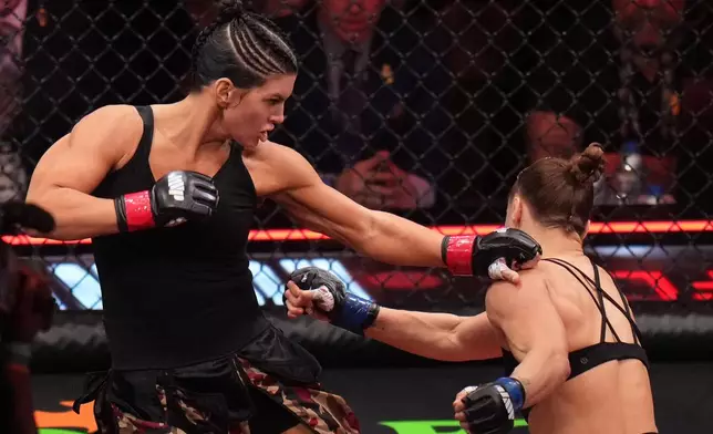 Gina Carano, of the United States, left, fights Ronda Rousey, of the United States, during their featherweight mixed martial arts fight Saturday, May 16, 2026, in Inglewood, Calif. (AP Photo/Jae C. Hong )