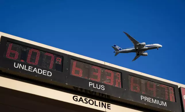FILE - An ANA jet flies above a gas station in Inglewood, Calif., on May 6, 2026. (AP Photo/Jae C. Hong, File)
