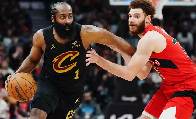 Cleveland Cavaliers' James Harden (1) drives past Toronto Raptors' Jamison Battle, right, during the first half of Game 6 in the first round of an NBA basketball playoffs series in Toronto, Friday, May 1, 2026. (Frank Gunn/The Canadian Press via AP)