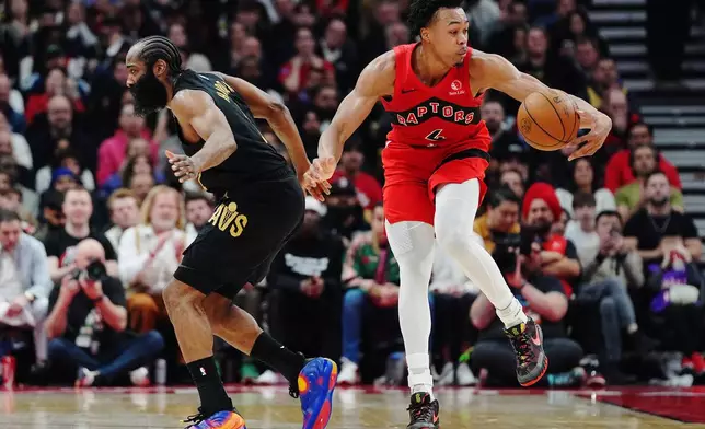 Toronto Raptors' Scottie Barnes (4) drives past Cleveland Cavaliers' James Harden (1) during the first half of Game 6 in the first round of an NBA basketball playoffs series in Toronto on Friday, May 1, 2026. (Frank Gunn/The Canadian Press via AP)