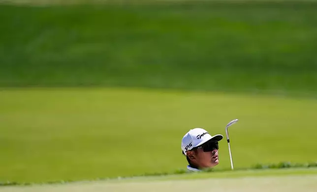 Ryo Hisatsune, of Japan, hits out of the bunker on the 16th green during a PGA Championship golf tournament practice round at Aronimink Golf Club, Tuesday, May 12, 2026, in Newtown Square, PA. (AP Photo/Matt Slocum)