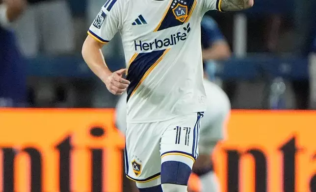 LA Galaxy forward Gabriel Pec celebrates after scoring a goal during the second half of an MLS soccer match against Sporting Kansas City, Wednesday, May 13, 2026, in Kansas City, Kan. (AP Photo/Charlie Riedel)
