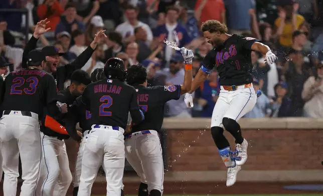 New York Mets' MJ Melendez reacts with teammates after hitting a walk off two run home run leading Vidal Bruján to score during the 10th inning of a baseball game against the Miami Marlins Friday, May 29, 2026, in New York. (AP Photo/Pamela Smith)