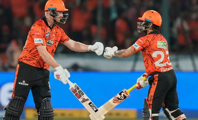 Sunrisers Hyderabad's Heinrich Klaasen, left and captain Ishan Kishan interacts after Klaasen hits a six during the Indian Premier League cricket match between Sunrisers Hyderabad and Royal Challengers Bengaluru in Hyderabad, India, Friday, May 22, 2026. (AP Photo/Mahesh Kumar A.)