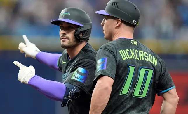 Tampa Bay Rays' Nick Fortes, left, celebrates his RBI single off Miami Marlins pitcher Pete Fairbanks with first base coach Corey Dickerson during the ninth inning of a baseball game Saturday, May 16, 2026, in St. Petersburg, Fla. (AP Photo/Chris O'Meara)