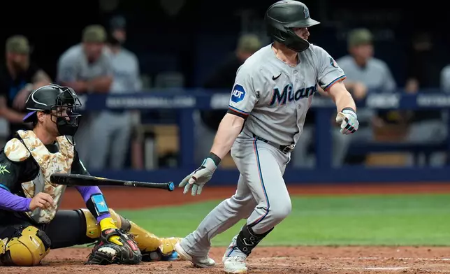 Miami Marlins' Liam Hicks watches his two-run single off Tampa Bay Rays pitcher Hunter Bigge during the 10th inning of a baseball game Saturday, May 16, 2026, in St. Petersburg, Fla. (AP Photo/Chris O'Meara)