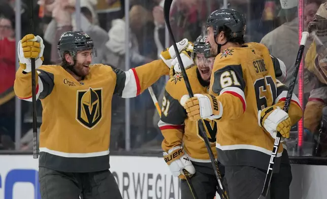 Vegas Golden Knights center Brett Howden, second from left, celebrates after scoring against the Anaheim Ducks during the second period of Game 1 of a second-round NHL hockey Stanley Cup playoff series Monday, May 4, 2026, in Las Vegas. (AP Photo/John Locher)