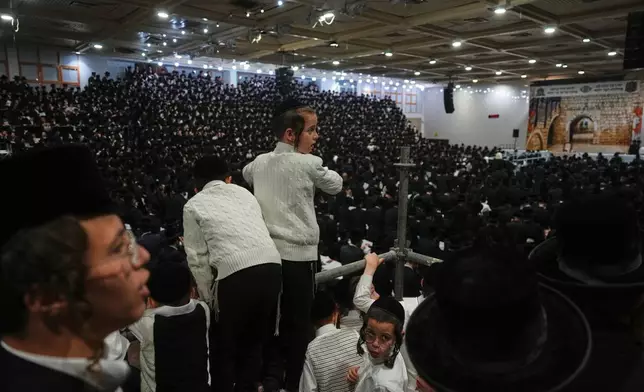 Ultra-Orthodox Jews celebrate the holiday of Lag BaOmer, traditionally marked by bonfire, music, and communal celebrations, in Netanya, Israel, Monday, May 4, 2026. (AP Photo/Ariel Schalit)