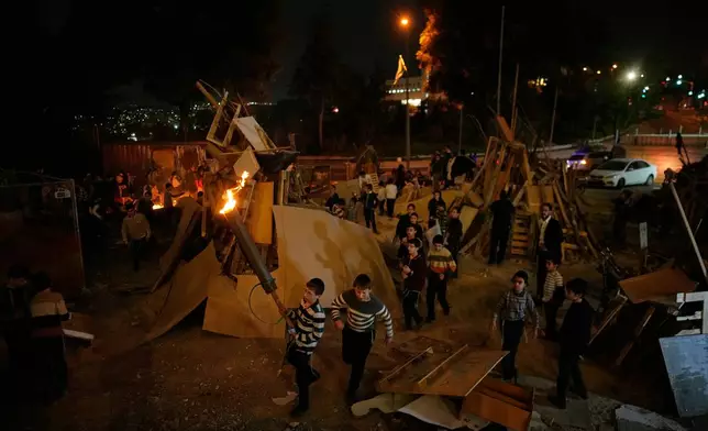 Ultra-Orthodox Jewish boys prepare to light a bonfire during Lag BaOmer, a holiday traditionally celebrated with bonfires, music, and gatherings in Jerusalem, Monday, May 4, 2026. (AP Photo/Ohad Zwigenberg)
