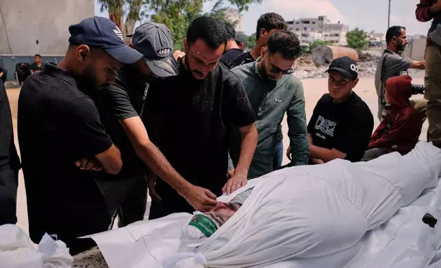 Palestinians mourn over the body of Mohammad Odeh, whom Israel says was a leader of Hamas Qassam Brigades, a day after he was killed in an Israeli airstrike, during his funeral in Gaza City, Wednesday, May 27, 2026. (AP Photo/Jehad Alshrafi)