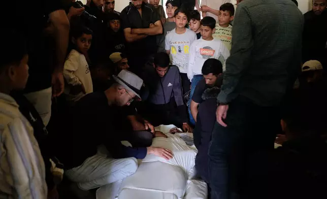 Palestinians mourn over the body of Mohammad Odeh, whom Israel says was a leader of Hamas Qassam Brigades, a day after he was killed in an Israeli airstrike, during his funeral in Gaza City, Wednesday, May 27, 2026. (AP Photo/Jehad Alshrafi)