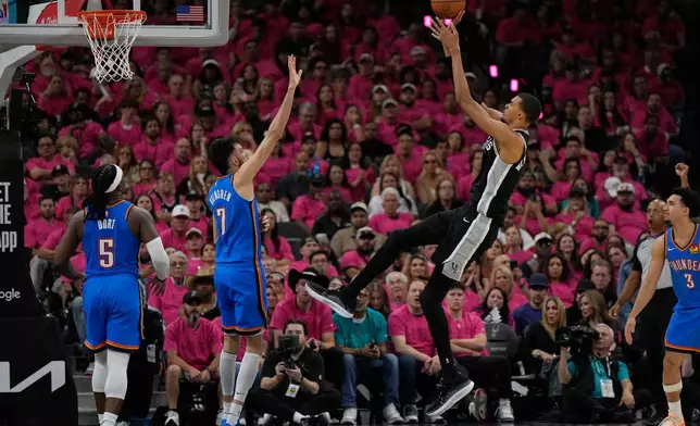 San Antonio Spurs forward Victor Wembanyama shoots over Oklahoma City Thunder center Chet Holmgren (7) during the second half of Game 3 in the Western Conference finals NBA basketball playoffs series Friday, May 22, 2026, in San Antonio. (AP Photo/Ashley Landis)
