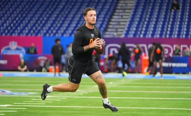 FILE - Miami quarterback Carson Beck (04) runs a drill at the NFL football scouting combine in Indianapolis, Saturday, Feb. 28, 2026. (AP Photo/Julio Cortez, File)