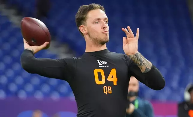 FILE - Miami quarterback Carson Beck (04) runs a drill at the NFL football scouting combine in Indianapolis, Feb. 28, 2026. (AP Photo/Julio Cortez, File)