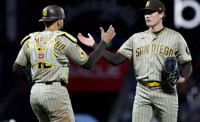 San Diego Padres pitcher Ron Marinaccio, right, celebrates with catcher Luis Campusano (12) after the team's victory over the San Francisco Giants in a baseball game in San Francisco, Tuesday, May 5, 2026. (AP Photo/Jed Jacobsohn)