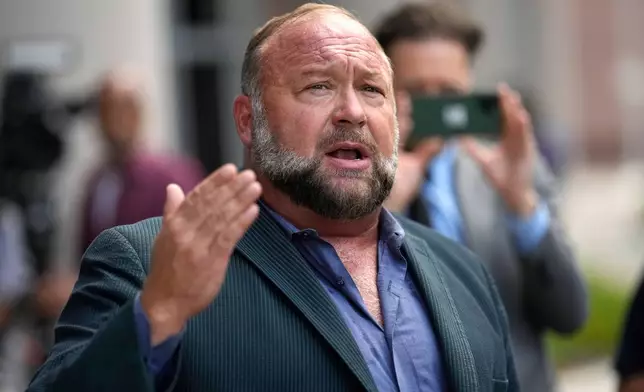 FILE - Right-wing conspiracy theorist Alex Jones speaks to the media after arriving at the federal courthouse for a hearing in front of a bankruptcy judge, June 14, 2024, in Houston. (AP Photo/David J. Phillip, File)