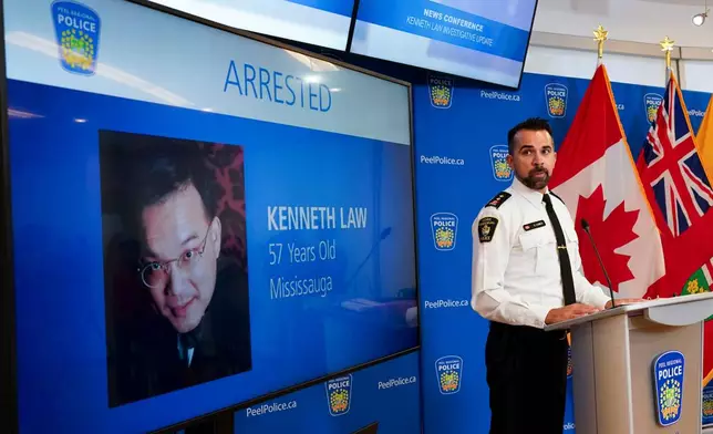 FILE - York Regional Police Inspector Simon James speaks during a news conference in Mississauga, Ont., Aug. 29, 2023, with the image of Kenneth Law, a Canadian man accused of selling lethal substances on the internet to people at risk of self harm, displayed on screen. (Arlyn McAdorey/The Canadian Press via AP, File)