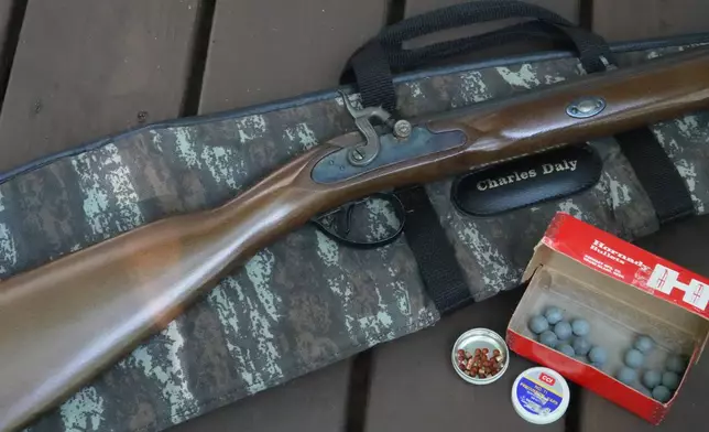 A .50-caliber Hawken replica rifle with lead balls and percussion caps sits on a deck in Wake Forest, N.C., on Monday, May 4, 2026. (AP Photo/Allen G. Breed)