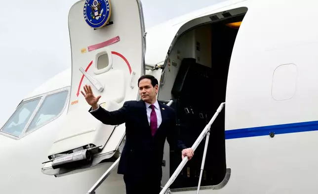US Secretary of State Marco Rubio waves as he boards a US government aircraft after concluding his two-day visit to Italy and the Vatican, at Ciampino airport in Rome, Friday, May 8, 2026. (Stefano Rellandini/Pool Photo via AP)