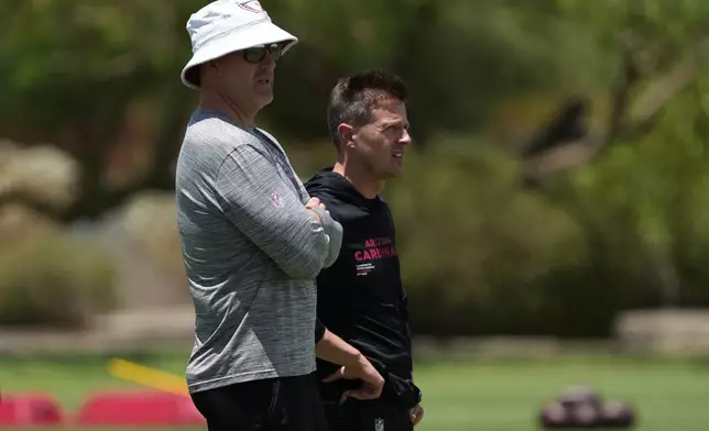 Arizona Cardinals GM Monti Ossenfort, left, head coach Mike LaFleur talk during the NFL football team's practice, Wednesday, May 27, 2026, in Tempe, Ariz. (AP Photo/Rick Scuteri)