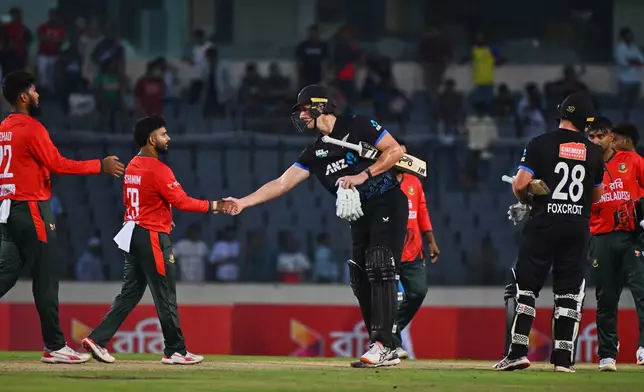 New Zealand's Bevon Jacobs shakes hands with Bangladesh's players after winning the third T20 international cricket match between Bangladesh and New Zealand in Mirpur, Bangladesh, Saturday, May 2, 2026. (AP Photo/Mosaraf Hossain)