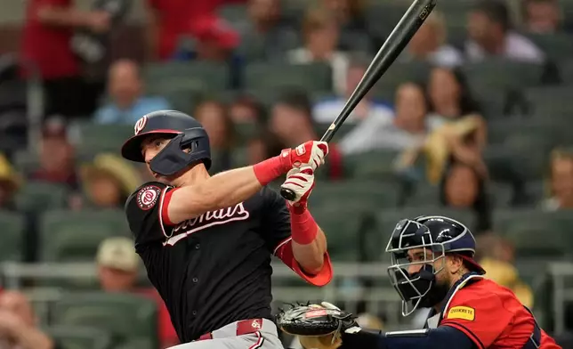 Washington Nationals' Jacob Young (30) hits a single in the fifth inning of a baseball game against the Atlanta Braves, Friday, May 22, 2026, in Atlanta. (AP Photo/Mike Stewart)