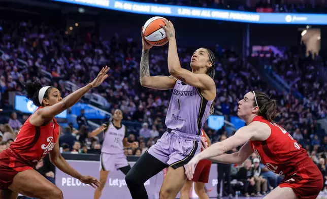 Golden State Valkyries' Gabby Williams (1) drives to basket between Indiana Fevers' Monique Billings (25) and Caitlin Clark (22) during the first half of a WNBA basketball game in San Francisco on Thursday, May 28, 2026. (Carlos Avila Gonzalez/San Francisco Chronicle via AP)