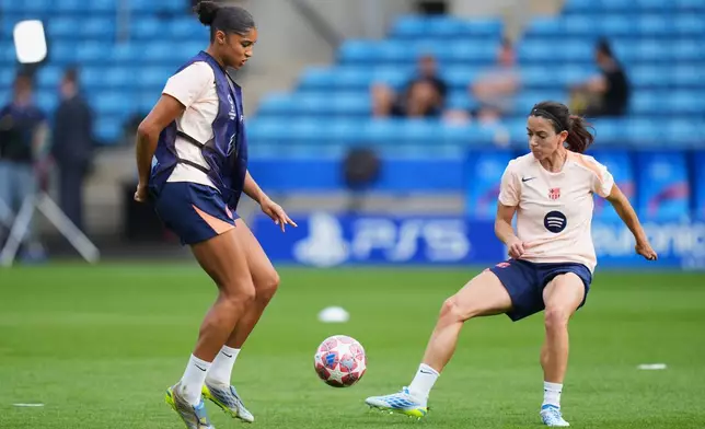 Barcelona's Aitana Bonmati, right, and Sydney Schertenleib play with a ball during a training session on the eve of the Women's Champions League final soccer match between FC Barcelona and OL Lyonnes, in Oslo, Friday, May 22, 2026. (AP Photo/Kirsty Wigglesworth)