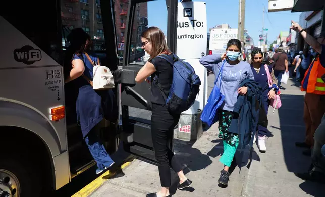 Commuters board buses to Long Island outside of the Jamaica–179th Street station as Long Island Rail Road workers enter the third day of their strike, Monday, May 18, 2026, in New York. (AP Photo/Heather Khalifa)