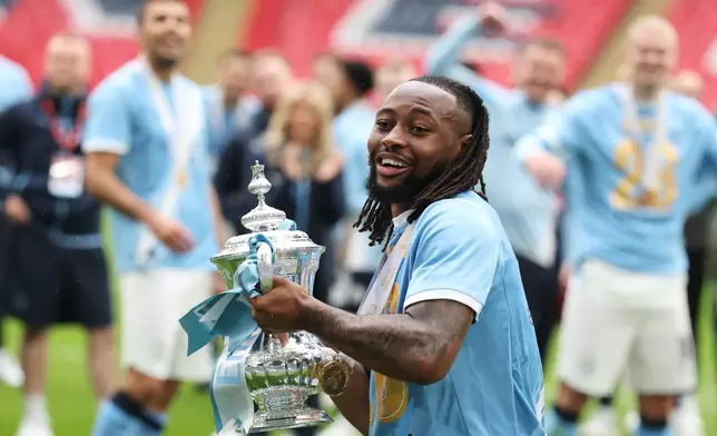 Manchester City's Antoine Semenyo holds the winner's trophy after the English FA Cup final soccer match between Chelsea and Manchester City in London, Saturday, May 16, 2026. (AP Photo/Richard Pelham)