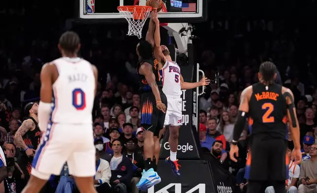 New York Knicks forward Og Anunoby, center left, blocks Philadelphia 76ers guard Quentin Grimes (5) during the first half of Game 2 in a second-round NBA basketball playoffs series, Wednesday, May 6, 2026, in New York. (AP Photo/Yuki Iwamura)