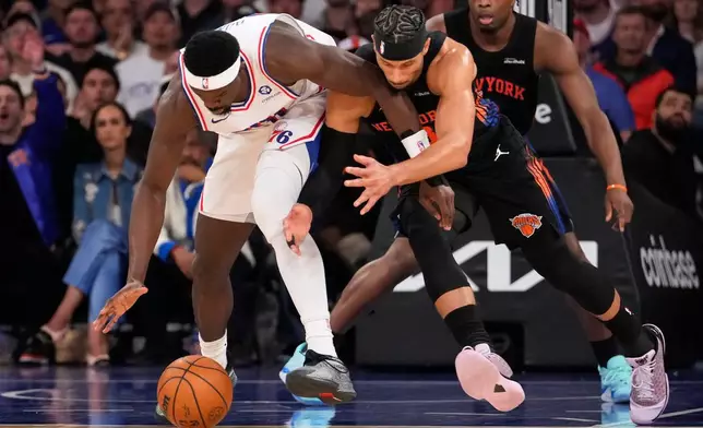 Philadelphia 76ers center Adem Bona, right, fights for control of the ball with New York Knicks guard Josh Hart during the first half of Game 2 in a second-round NBA basketball playoffs series, Wednesday, May 6, 2026, in New York. (AP Photo/Yuki Iwamura)