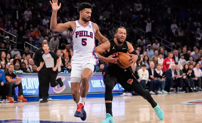 New York Knicks guard Jalen Brunson, right, drives past Philadelphia 76ers guard Quentin Grimes (5) during the first half of Game 2 in a second-round NBA basketball playoffs series, Wednesday, May 6, 2026, in New York. (AP Photo/Yuki Iwamura)