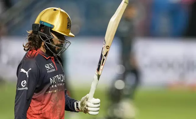 Royal Challengers Bengaluru's captain Rajat Patidar acknowledges the applause from the crowd as he leaves the field at the end of their innings during the Indian Premier League cricket match between Gujarat Titans and Royal Challengers Bengaluru in Dharamshala, India, Tuesday, May 26, 2026. (AP Photo/Ashwini Bhatia)
