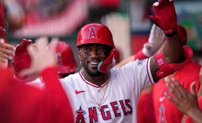 Los Angeles Angels' Jorge Soler is congratulated by teammates in the dugout after hitting a two-run home run during the first inning of a baseball game lagainst the New York Mets, Friday, May 1, 2026, in Anaheim, Calif. (AP Photo/Mark J. Terrill)
