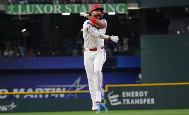 Texas Rangers' Ezequiel Duran celebrates after his walkoff single that scored teammate Brandon Nimmo in the ninth inning of a baseball game against the Kansas City Royals, Saturday, May 30, 2026, in Arlington, Texas. (AP Photo/LM Otero)