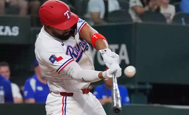 Texas Rangers' Ezequiel Duran hits a walkoff single that scored teammate Brandon Nimmo in the ninth inning of a baseball game against the Kansas City Royals, Saturday, May 30, 2026, in Arlington, Texas. (AP Photo/LM Otero)