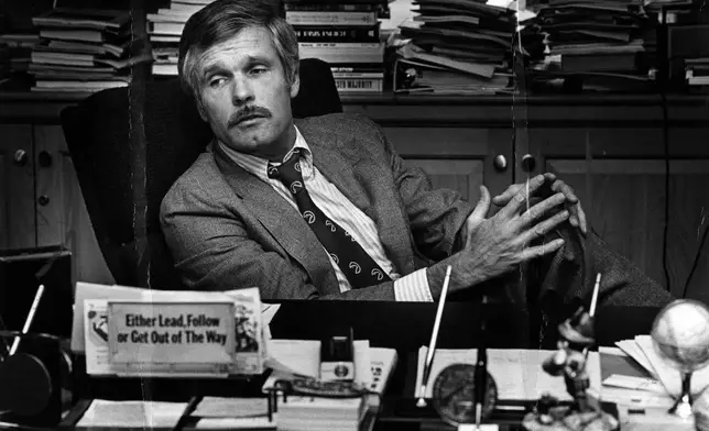 FILE - Ted Turner is seen at his desk inside the CNN Center in 1982. (Nancy Mangiafico/Atlanta Journal-Constitution via AP, File)