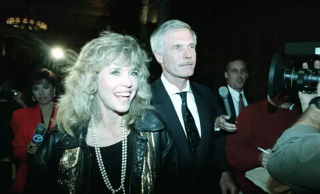 FILE - Actress and political activist Jane Fonda and media mogul Ted Turner arrive at a party in support of Proposition 128 in Los Angeles on Nov. 6, 1990. (AP Photo/Reed Saxon, File)